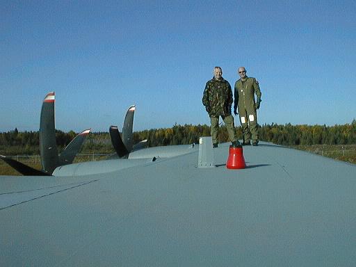 On roof of a Hercules with 2 strange looking Geezers!